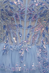 The image showcases the intricate back design of a mini dress featuring a stunning array of sequined floral patterns in shades of blue and pink.