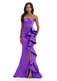 A model showcases a striking strapless purple gown featuring a corset bustier and a cascading ruffle detail. This elegant dress is perfect for events like prom, galas, or black tie weddings and is available near Apex, Cary, and Raleigh.