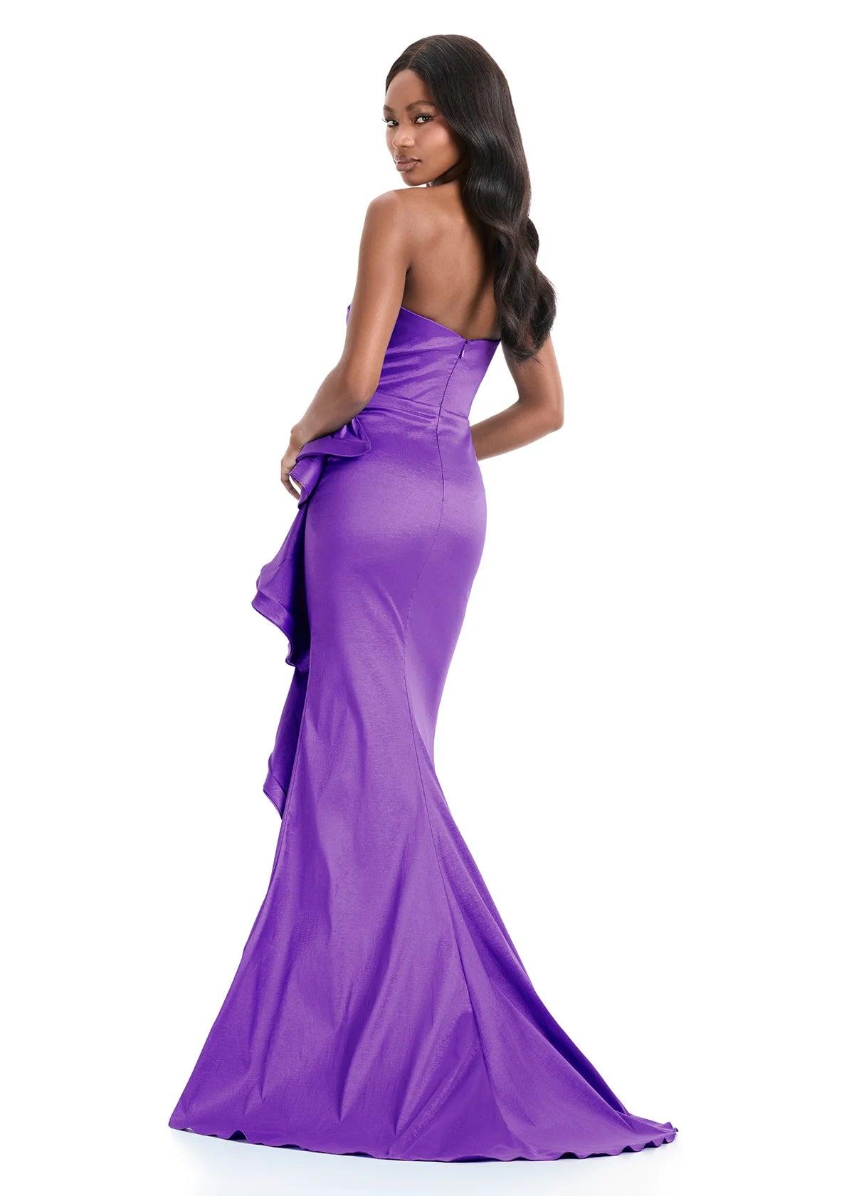 A model showcases a stunning strapless purple gown with a corset-style bodice and a flowing, ruched skirt. Perfect for elegant events like proms, galas, or black-tie weddings, this dress is conveniently available near Apex, Cary & Raleigh.