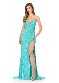 A stunning turquoise gown with intricate beading and a fitted silhouette, featuring a plunging neckline and a thigh-high slit. Perfect for prom, galas, or black tie weddings, this dress is conveniently located near Apex, Cary, and Raleigh.