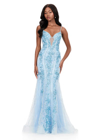 A model showcases a stunning ice blue gown with intricate embellishments and a fitted silhouette, perfect for a gala or black tie wedding. This elegant dress is conveniently available near Apex, Cary, and Raleigh for special occasions.