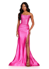 A model showcases a stunning fuchsia strapless gown featuring a straight neckline and a thigh-high slit, perfect for events like prom, galas, or black tie weddings. This elegant dress is conveniently available near Apex, Cary, and Raleigh.