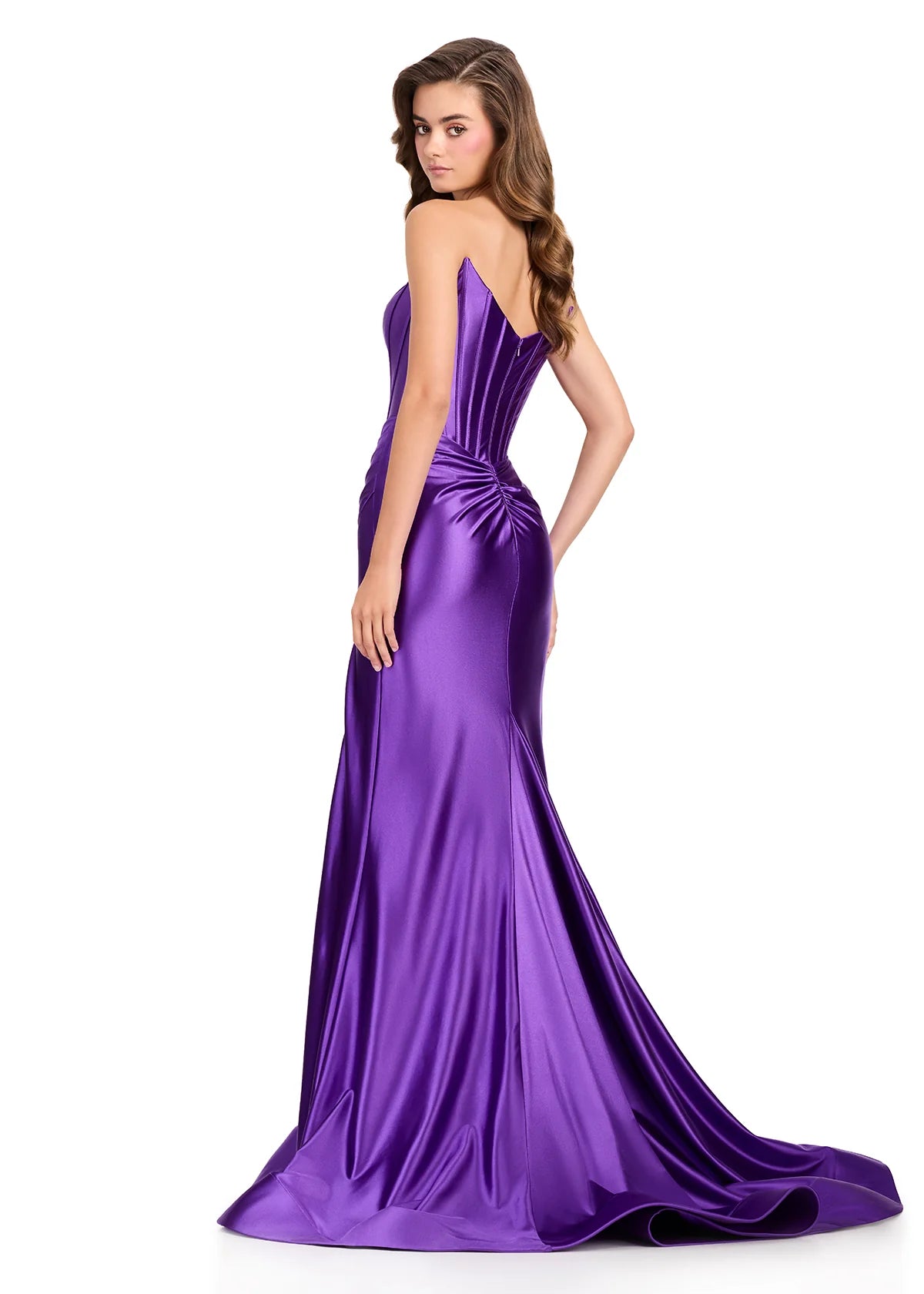 A model showcases a stunning purple strapless gown with a structured corset bodice and elegant train, ideal for formal events such as proms, galas, or weddings. Conveniently available near Apex, Cary, and Raleigh for your special occasion.