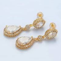 Elegant gold drop earrings featuring pear-shaped cubic zirconia stones surrounded by a micro-pave setting. Perfect for special occasions like weddings, galas, or proms, these stunning accessories are available near Apex, Cary, and Raleigh.