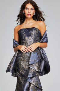A stunning strapless mermaid gown in gunmetal and gold features elegant side ruffles and a fitted bodice, perfect for formal events like galas or black tie weddings. Conveniently located for customers in Apex, Cary, and Raleigh.
