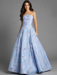 A woman models a stunning strapless blue gown featuring a textured design with shimmering accents. This elegant dress is perfect for formal events like galas or proms and is conveniently available near Apex, Cary, and Raleigh.