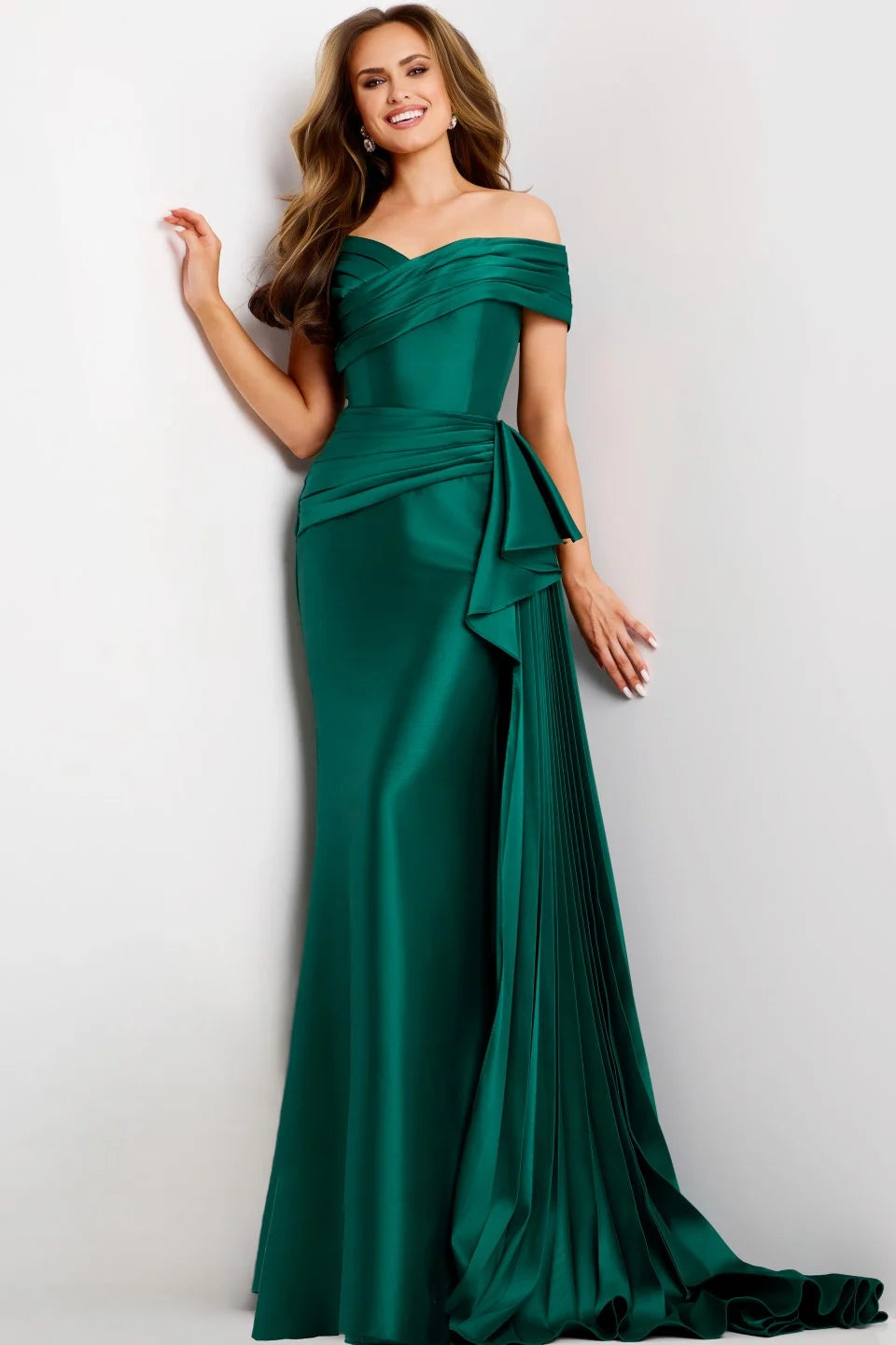 A model showcases a stunning emerald green floor-length gown with an off-the-shoulder sweetheart neckline and elegant draping. Perfect for events like prom, galas, or black tie weddings, this dress is available near Apex, Cary, and Raleigh.