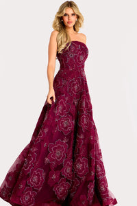 A stunning burgundy gown featuring a strapless neckline and an A-line silhouette, adorned with floral appliqué details and a layered skirt.