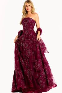 A stunning burgundy strapless gown featuring an embroidered tulle fabric adorned with floral appliqué details.