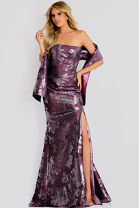 A model elegantly poses in a burgundy gown featuring a strapless design and a high slit, adorned with a floral pattern.