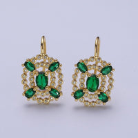 A pair of elegant gold drop earrings featuring an intricate design adorned with vibrant emerald gemstones and sparkling clear crystals. Perfect for adding a touch of sophistication to any formal event, such as a gala or black tie wedding.