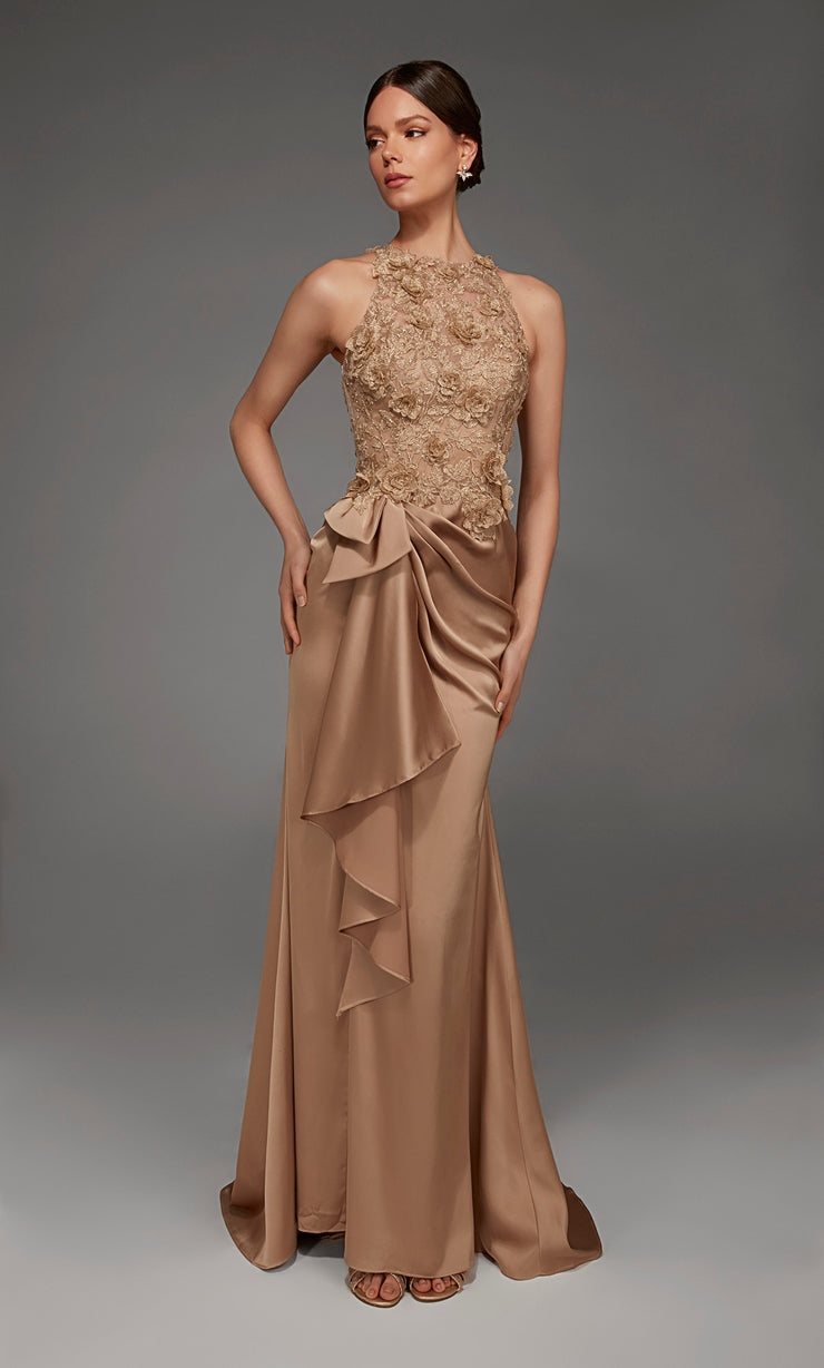 A model poses elegantly in a floor-length, antique gold gown featuring intricate beading on the bodice and a flowing skirt with a ruffled overlay.