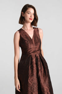 The Mariah Gown in a rich chocolate hue features a flattering V-neckline and a textured jacquard fabric, perfect for elegant occasions like a black tie wedding or gala. Available for pre-order near Apex, Cary, and Raleigh.