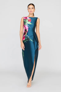 A model showcases a stunning blue opal column gown featuring a vibrant rose print and an elegant front slit.