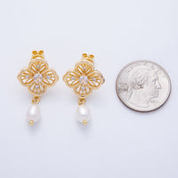 Gold flower filigree drop earrings feature intricate designs and a pearl accent, displayed next to a quarter for size reference.
