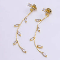 Elegant gold drop stud earrings featuring a delicate design with cubic zirconia stones arranged in a leaf pattern. Perfect for formal occasions like galas or weddings, these earrings add a touch of sophistication to any outfit.