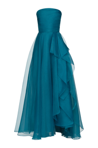 A stunning teal strapless gown featuring a draped design and flowing layers of lightweight organza. Perfect for elegant occasions like proms, galas, or black tie weddings, this dress is conveniently located near Apex, Cary, and Raleigh.