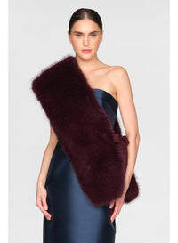 A model showcases a luxurious Kay Faux Fox Stole in Velvet Fig, draped elegantly over her shoulder. This stylish accessory adds warmth and sophistication to evening gowns, perfect for occasions like black tie weddings or galas.