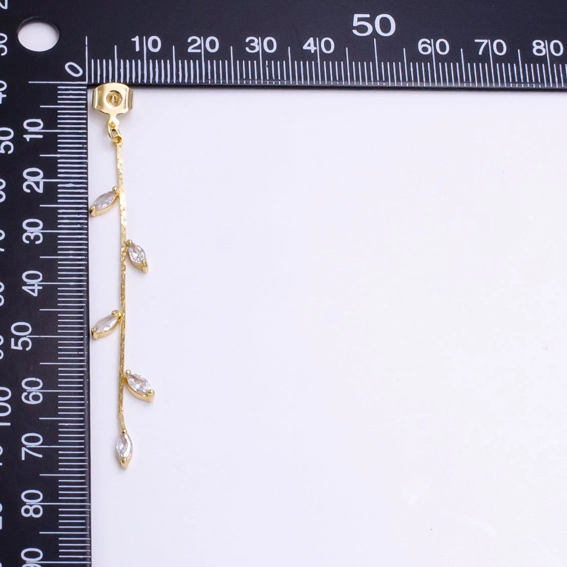 Gold leaf drop stud earrings featuring a delicate design with cubic zirconia accents. These elegant earrings are perfect for special occasions such as weddings, proms, or galas, and are conveniently located near Apex, Cary, and Raleigh.