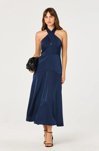 A model showcases a sleek navy satin dress with a halter neckline and a stylish keyhole detail, perfect for formal occasions like weddings or galas.