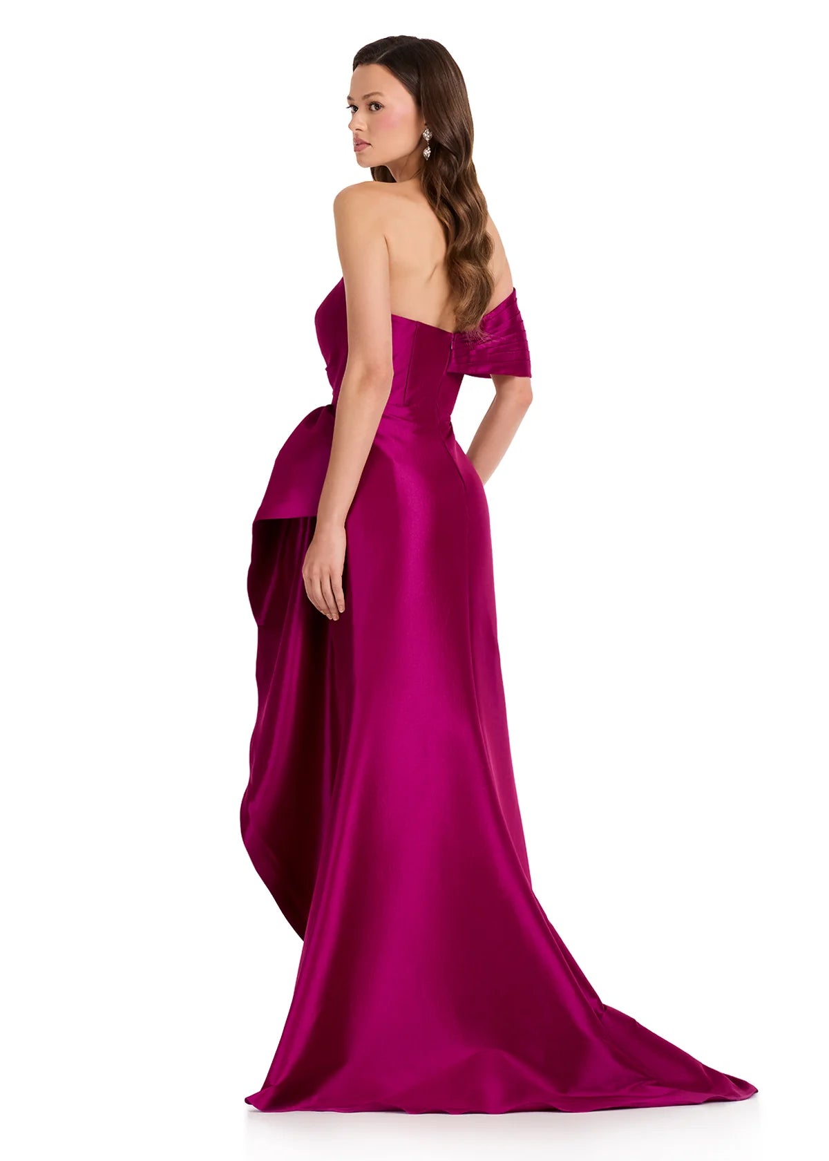 A model showcases a stunning berry-colored, one-shoulder gown with a flowing train and elegant silhouette, perfect for black tie weddings, galas, or proms. This chic dress is conveniently available near Apex, Cary, and Raleigh.