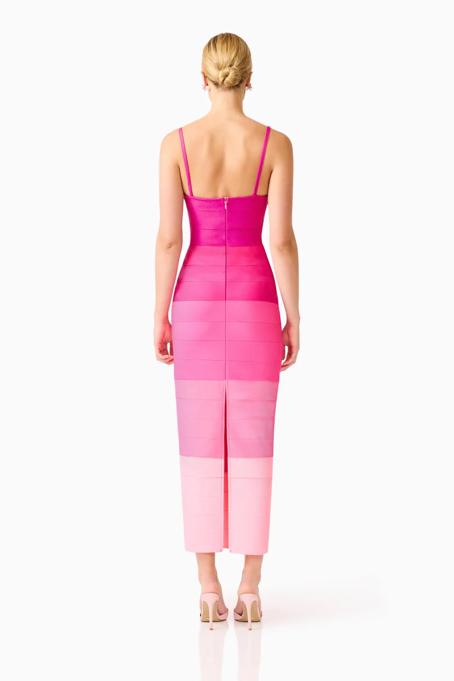 A model is seen from the back wearing a pink ombre gown featuring a square neckline and slim straps. This elegant dress, perfect for a gala or black tie wedding, is available near Apex, Cary, and Raleigh.