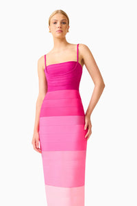 A model poses in a stunning pink ombre gown featuring a square neckline and thin straps. This elegant dress is perfect for special occasions like galas and weddings, and is conveniently available near Apex, Cary, and Raleigh.