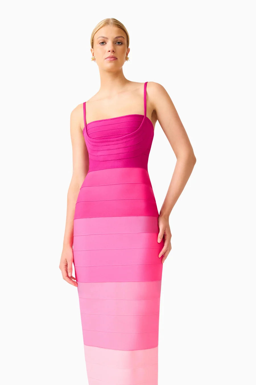 A model poses in a stunning pink ombre gown featuring a square neckline and thin straps. This elegant dress is perfect for special occasions like galas and weddings, and is conveniently available near Apex, Cary, and Raleigh.