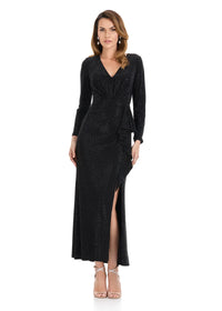 A model showcases an elegant full-length black gown with long sleeves and a stylish side slit, perfect for formal occasions like a black tie wedding or gala. This stunning dress is conveniently available near Apex, Cary, and Raleigh.