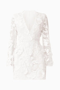 A stunning white mini dress featuring long flared sleeves and a deep V-neckline, elegantly designed with intricate 3D floral embellishments. Perfect for occasions like prom, homecoming, or a gala, available near Apex, Cary, and Raleigh.