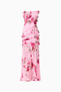 A stunning pink floral gown featuring a sleeveless design with elegant ruffles cascading down the front. This romantic piece is perfect for special occasions like weddings or galas and is conveniently located near Apex, Cary, and Raleigh.