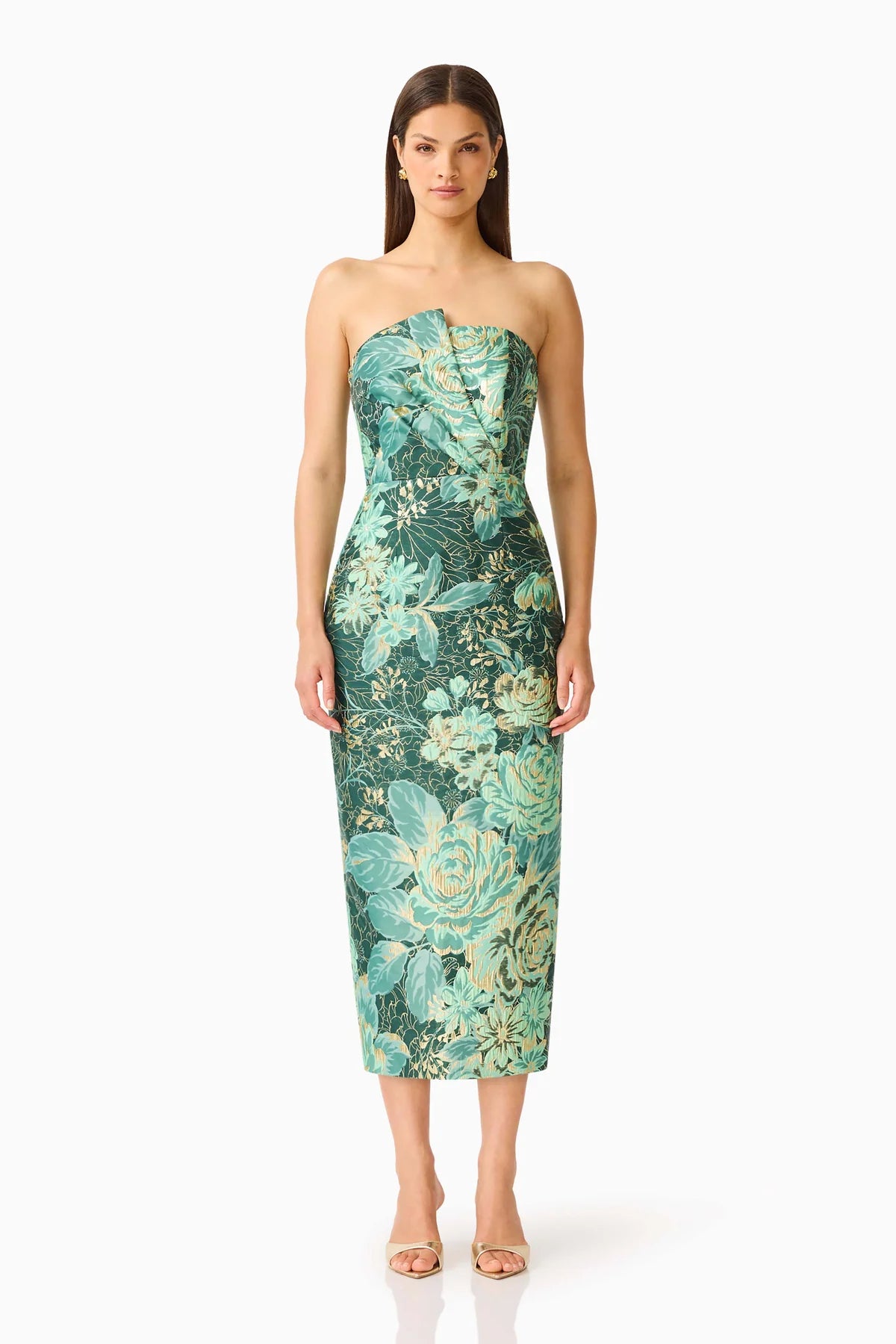 A model stands confidently in a strapless, floral midi dress featuring shades of teal and green. This elegant dress is perfect for special occasions like weddings or galas and is conveniently located near Apex, Cary, and Raleigh.