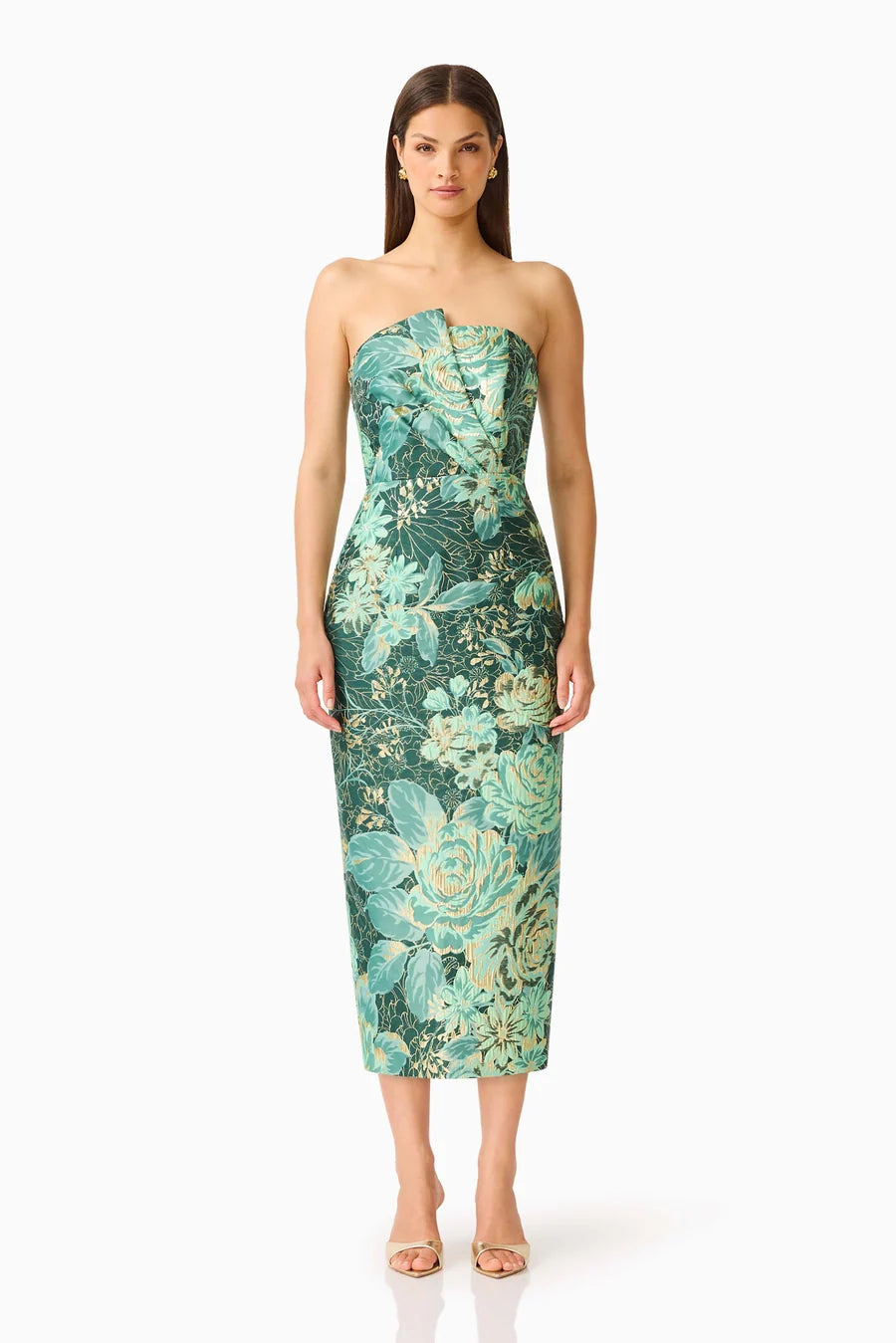 A model showcases a strapless, floral-printed midi dress with a fitted silhouette in shades of teal and green. This elegant dress is perfect for special occasions like weddings or galas, conveniently available near Apex, Cary, and Raleigh.