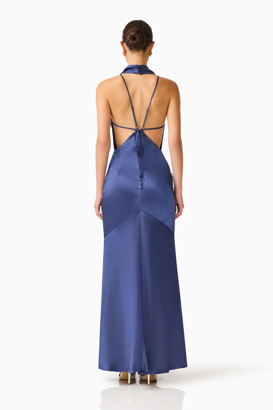 A model showcases the elegant Florea Cowl Neck Gown in navy, featuring a sophisticated back design with adjustable ties.