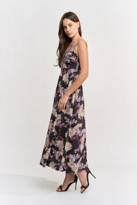 A model poses in a floral midi dress featuring a sweetheart neckline and spaghetti straps, set against a neutral background.