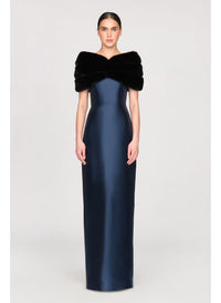 A model poses in a sleek, navy blue gown with a luxurious black faux mink shawl draped over the shoulders, perfect for elegant occasions like a black-tie wedding or gala.