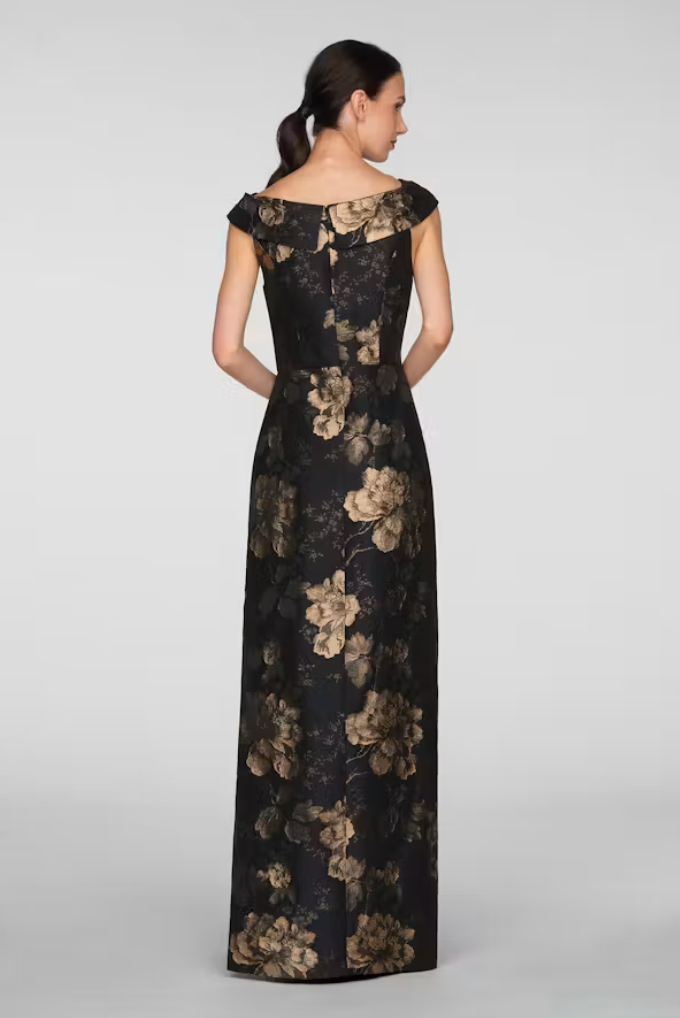 A woman is shown from the back wearing a long, black gown adorned with large gold floral patterns. This elegant dress is perfect for formal occasions like weddings, galas, or proms, and is conveniently available near Apex, Cary,.