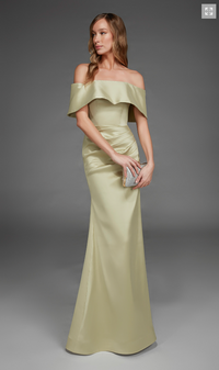 A model poses in an elegant off-the-shoulder gown in a soft honeydew color, featuring a fitted bodice and a flowing skirt.