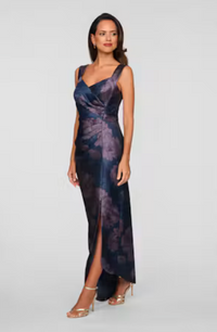 A model showcases the elegant Wesley Column Gown, featuring a fitted silhouette and a stylish side slit, perfect for formal events like galas or black tie weddings. This stunning dress is conveniently available near Apex, Cary, and Raleigh.