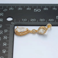 A close-up view of a gold drop stud earring featuring a geometric design, adorned with sparkling cubic zirconia.