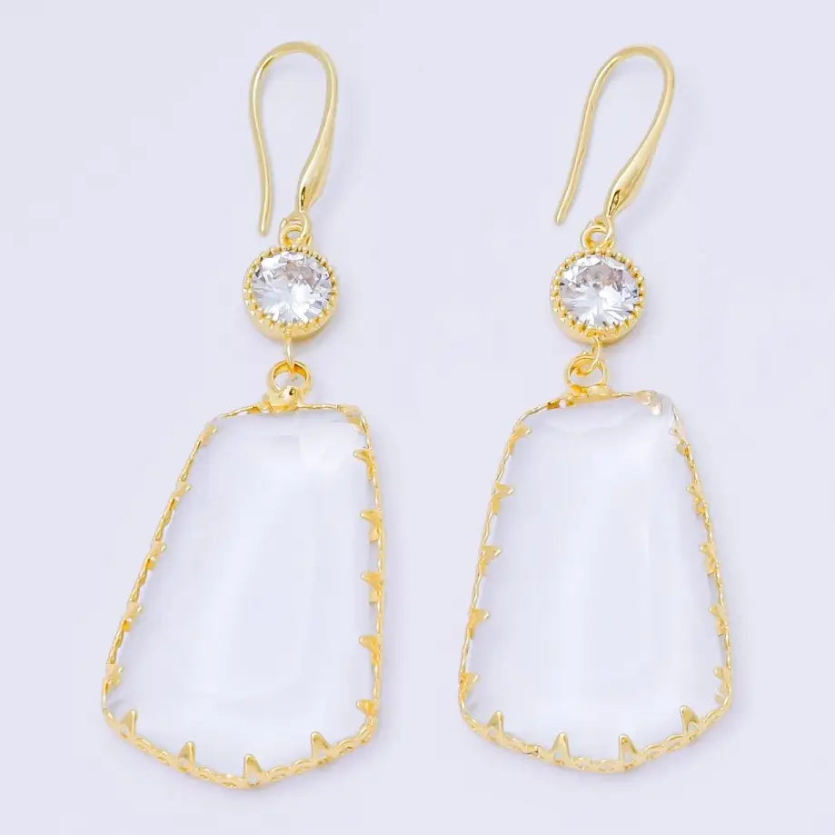 Elegant clear stone statement earrings feature a large, irregular-shaped clear stone with gold detailing and a sparkling cubic zirconia at the top. Perfect for adding a touch of glamour to any formal occasion, such as a gala or wedding.