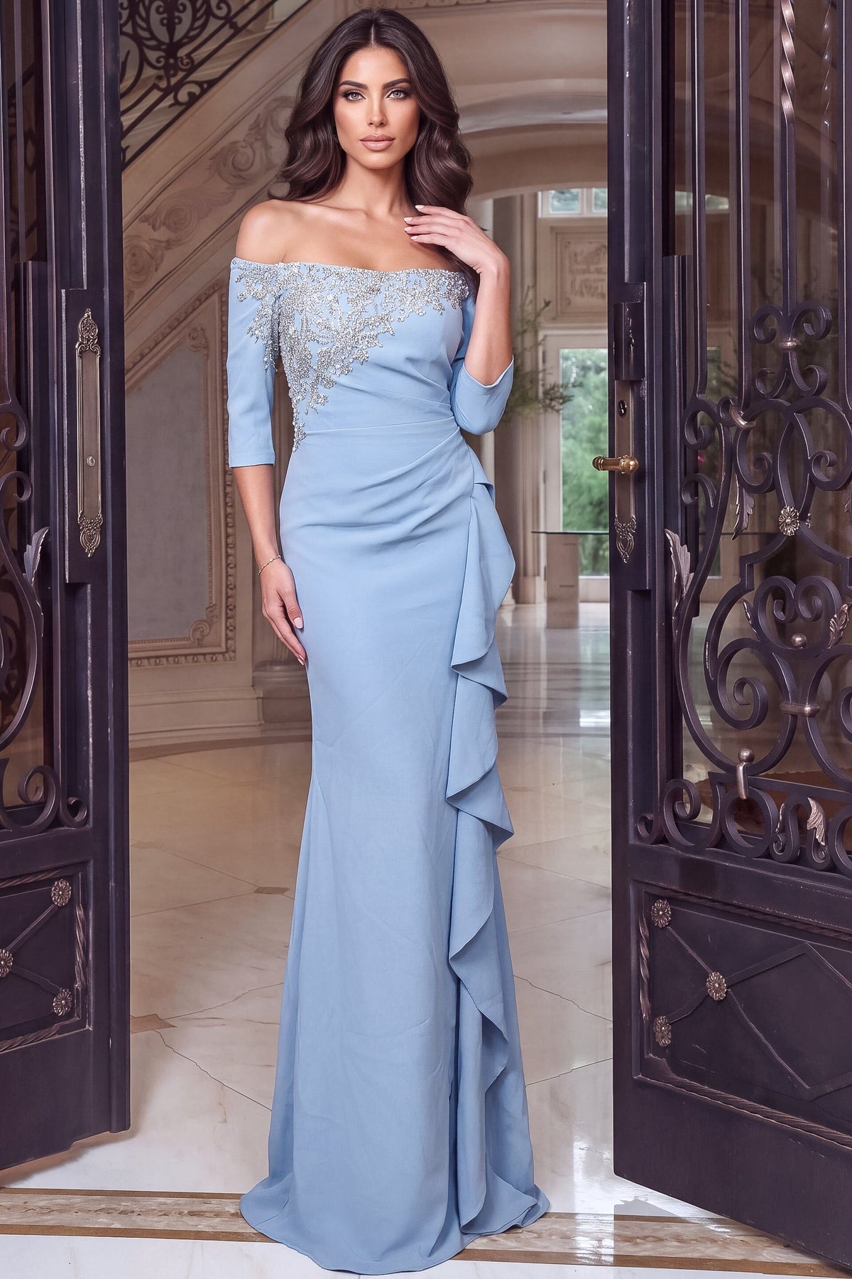 A stunning light blue gown featuring an off-the-shoulder design and elegant beaded detailing, complemented by cascading ruffles.