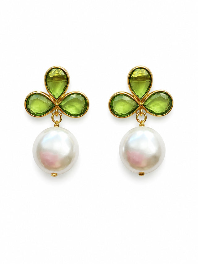A pair of elegant earrings featuring a gold-tone design with three green gemstones shaped like leaves and a large, round freshwater pearl pendant. These earrings are perfect for special occasions such as weddings, proms, or gala events.
