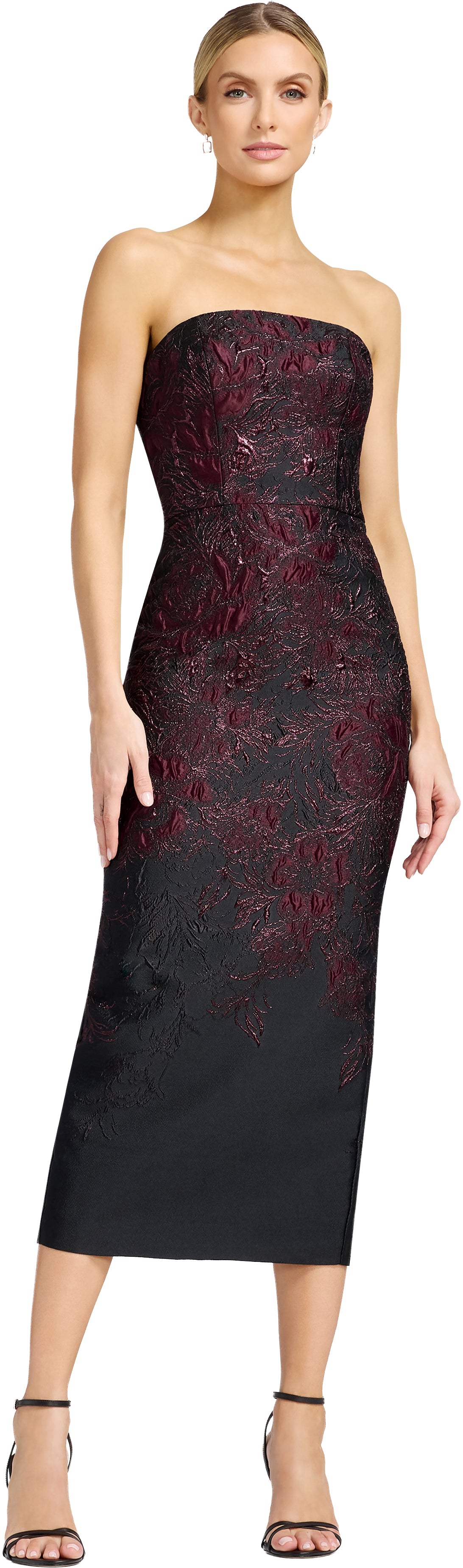 A model showcases a strapless, fitted midi dress featuring intricate burgundy and black floral embroidery, ideal for formal occasions like galas or weddings. This elegant gown is conveniently located near Apex, Cary, and Raleigh.